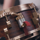 Sonique Drums custom Bubinga snare drum featuring the NATO-1 throw off