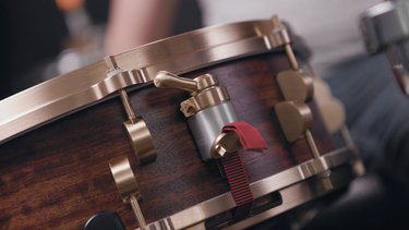 Sonique Drums custom Bubinga snare drum featuring the NATO-1 throw off