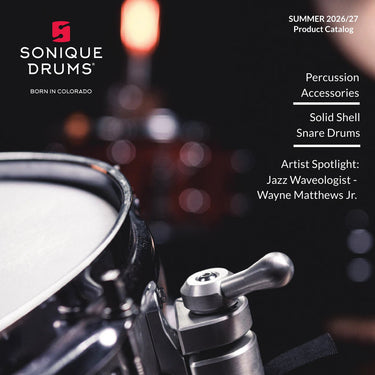 Sonique Drums Summer 2026/27 Product Catalog cover featuring a close-up of a snare drum hardware component, with text listing Percussion Accessories, Solid Shell Snare Drums, and Artist Spotlight: Jazz Waveologist - Wayne Matthews Jr.